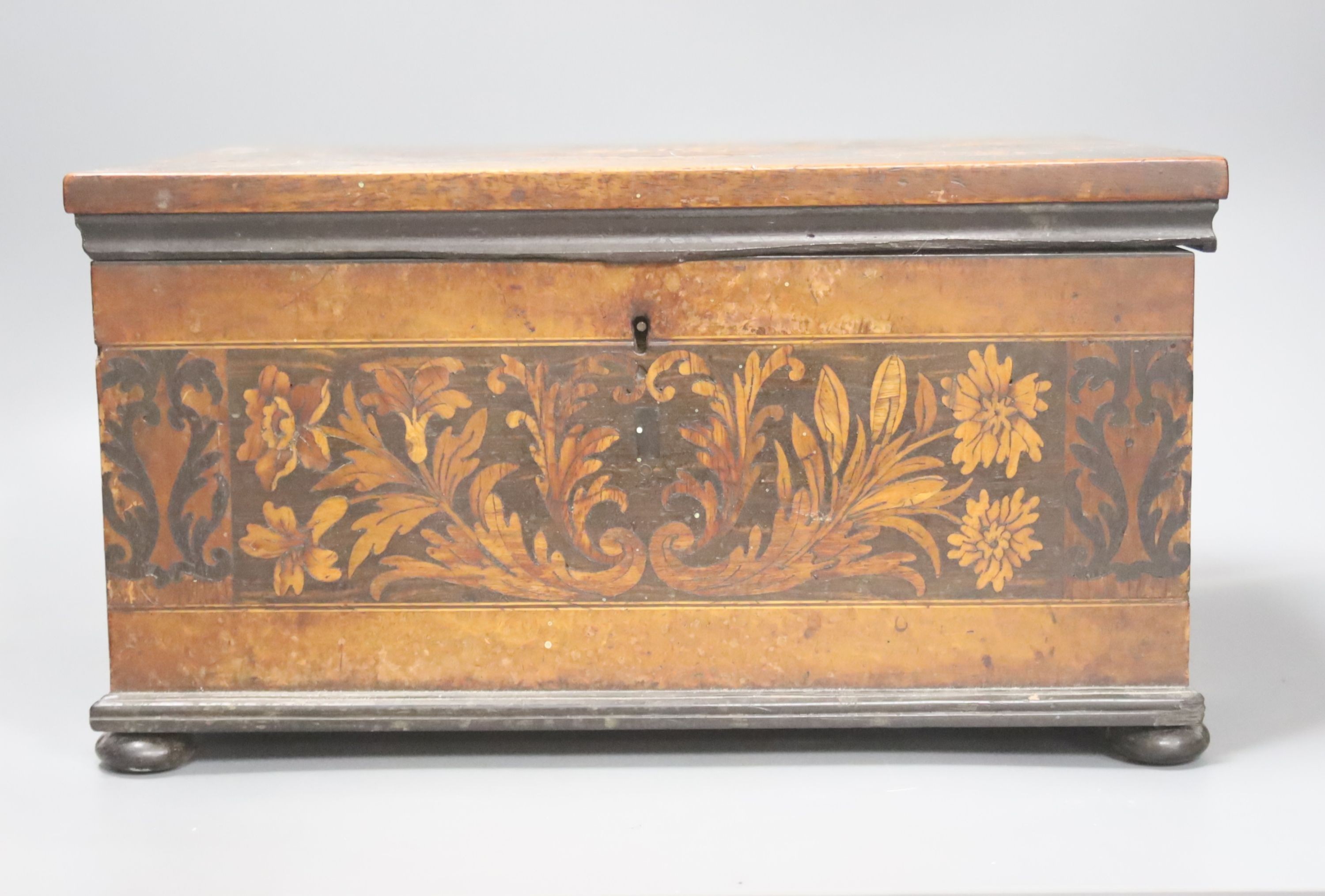 An unusual George IV ebony and marquetry inlaid tea caddy, 32cm